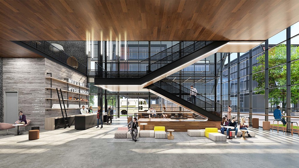 People sitting on benches in a building.